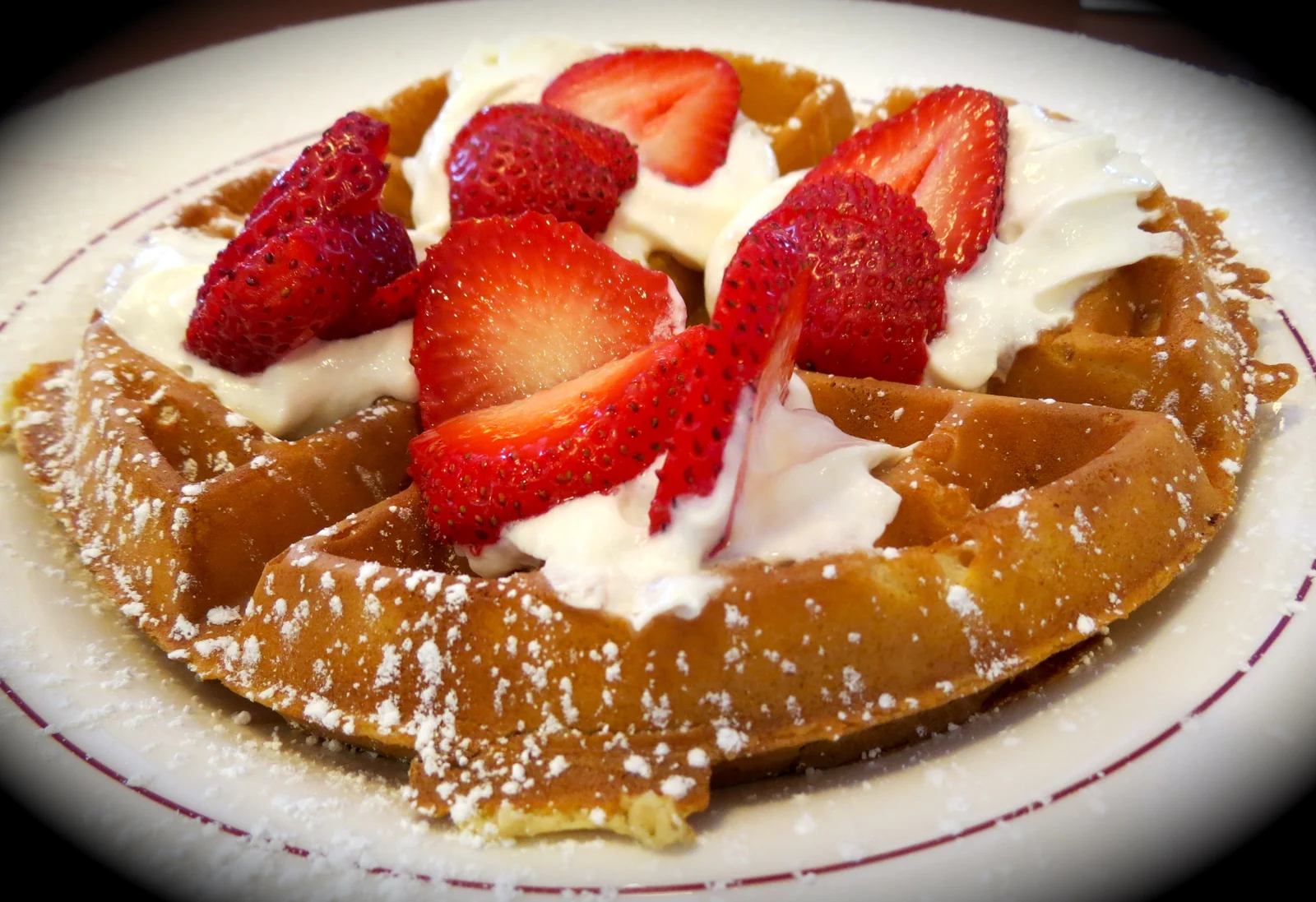 Belgian waffle with strawberries and whipped cream at Towson Diner